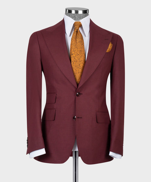 Burgundy tailored suit jacket with vest and white shirt; mustard patterned tie visible