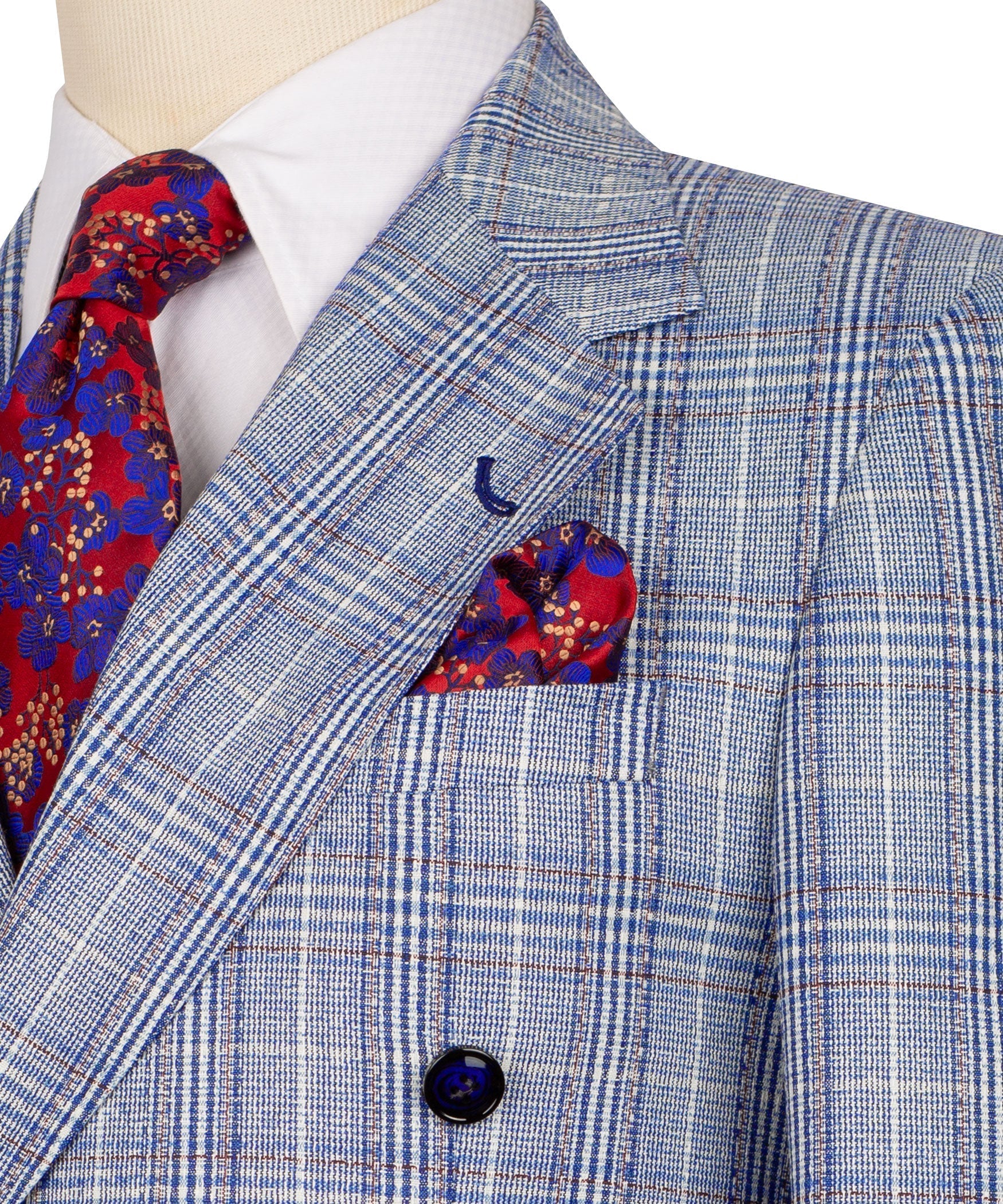 Close-up: light blue plaid jacket lapel with red pocket square and navy button