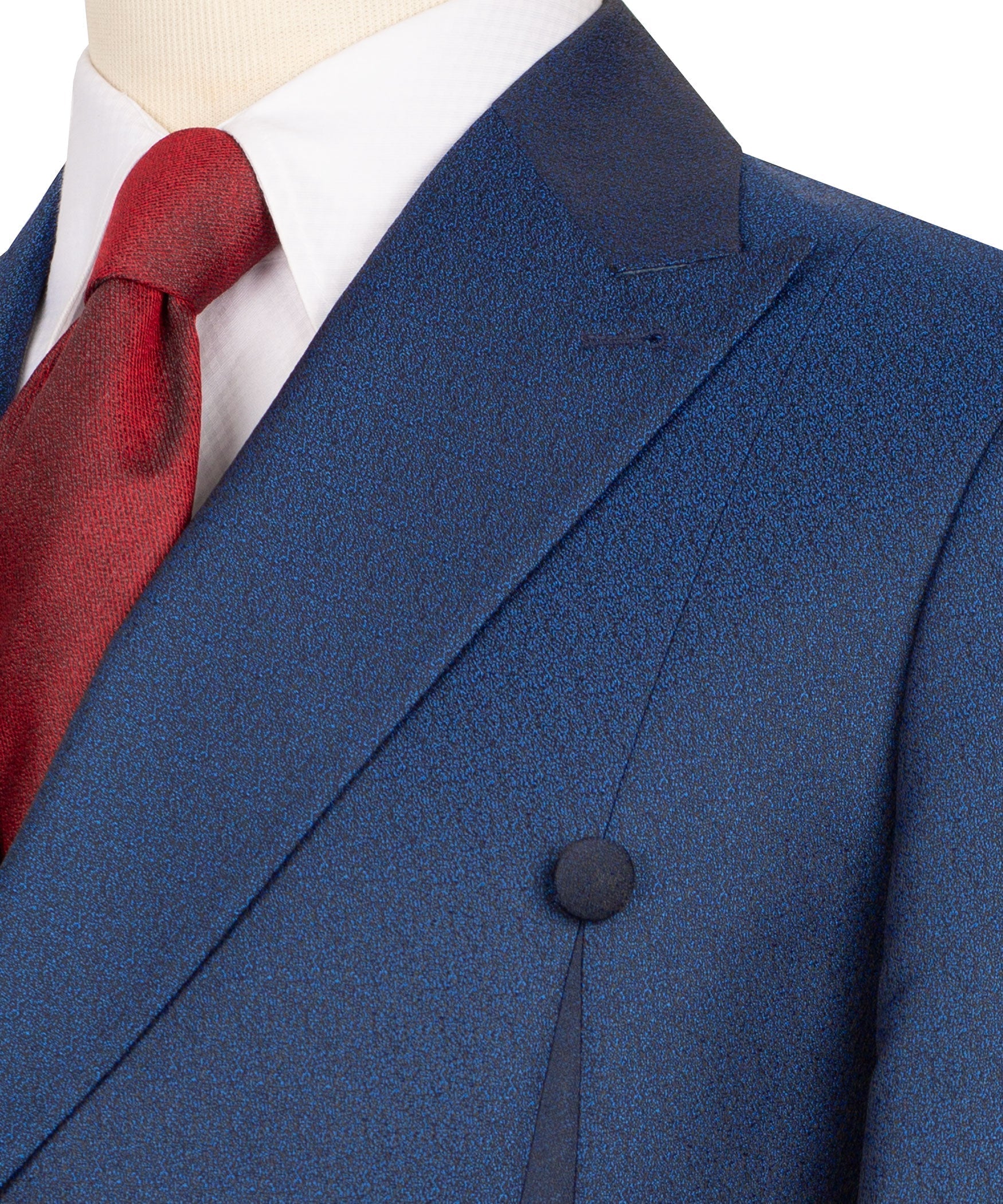 Blue suit lapel and breast pocket detail with textured fabric and red tie knot
