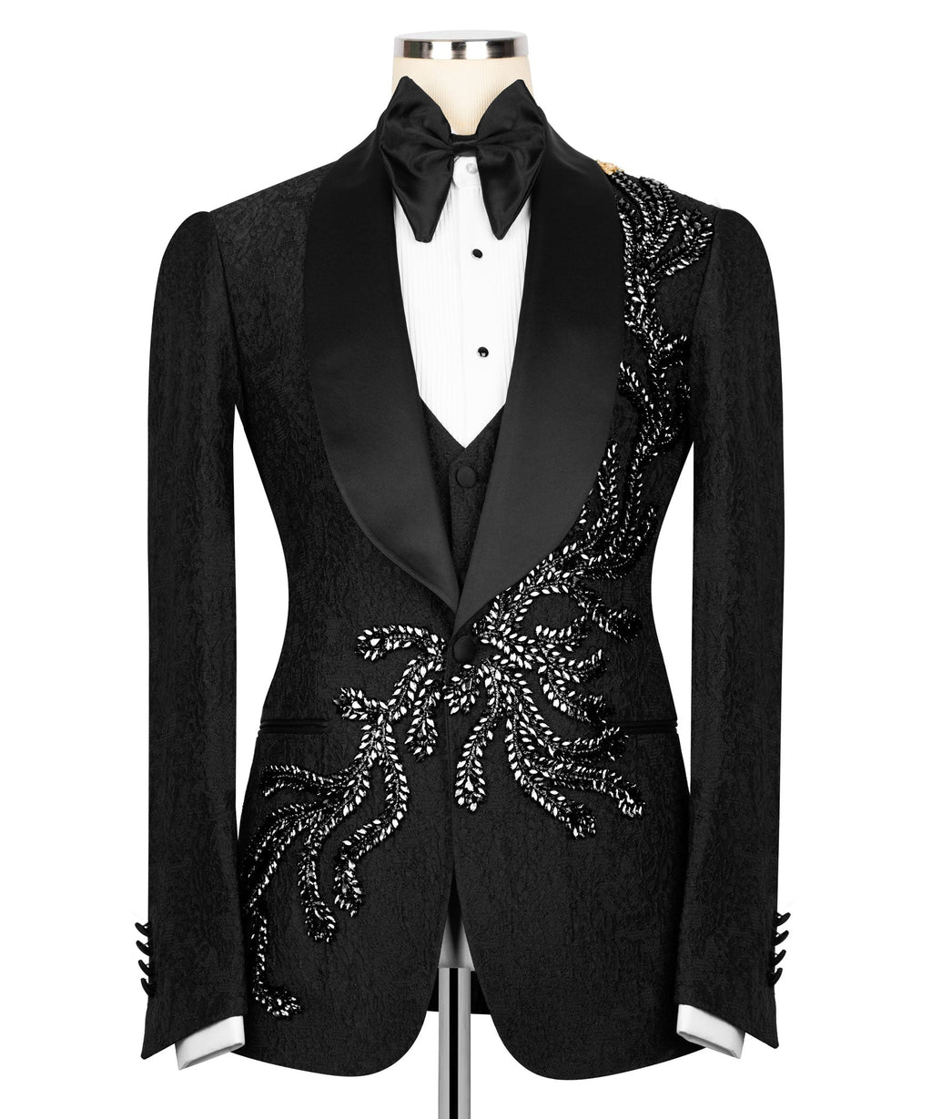Black tuxedo jacket with embroidered stone motifs and satin lapels, bow tie