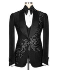 Black tuxedo jacket with embroidered stone motifs and satin lapels, bow tie