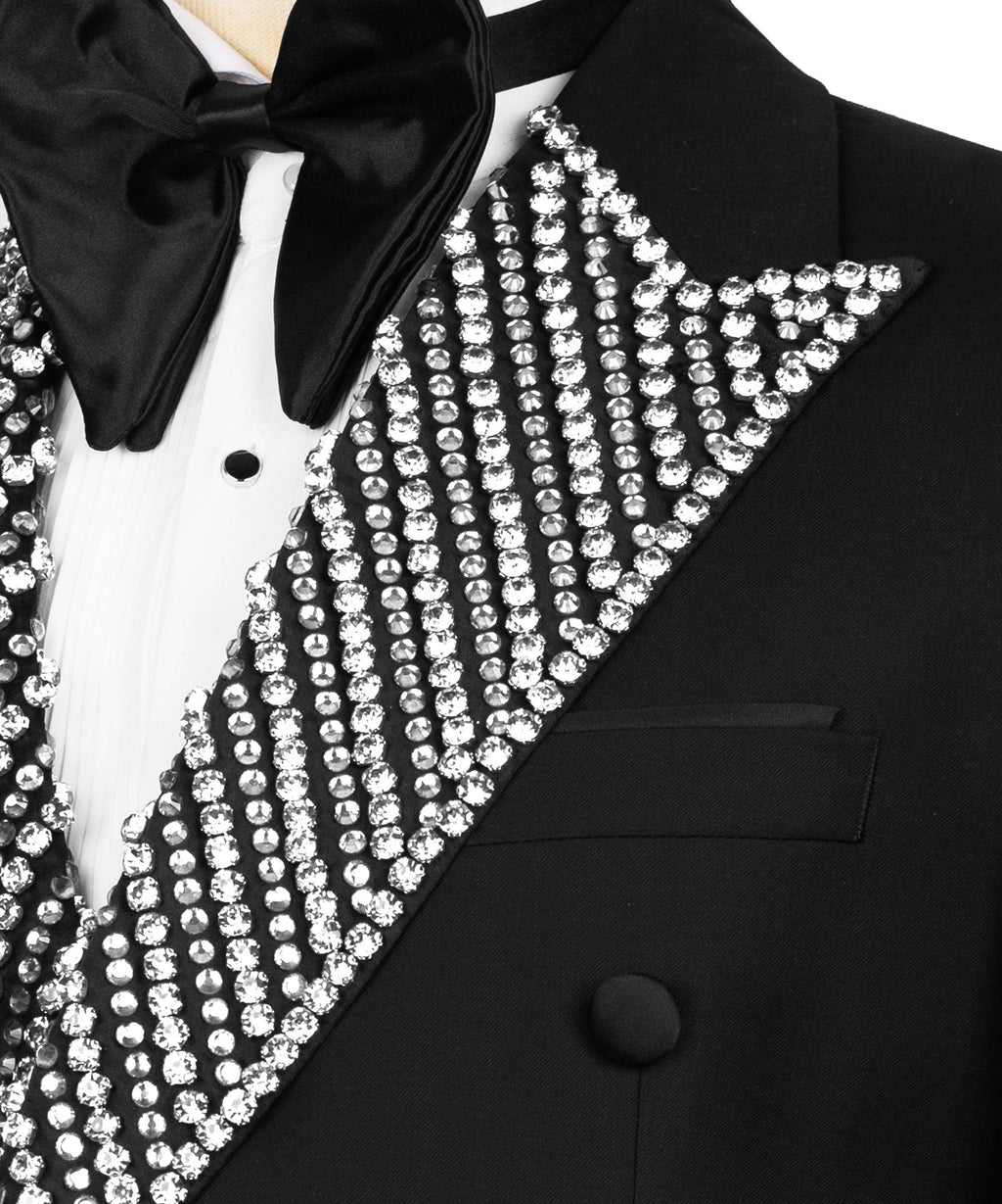 Close-up of black tuxedo lapel with vertical rhinestone embellishment and bow tie