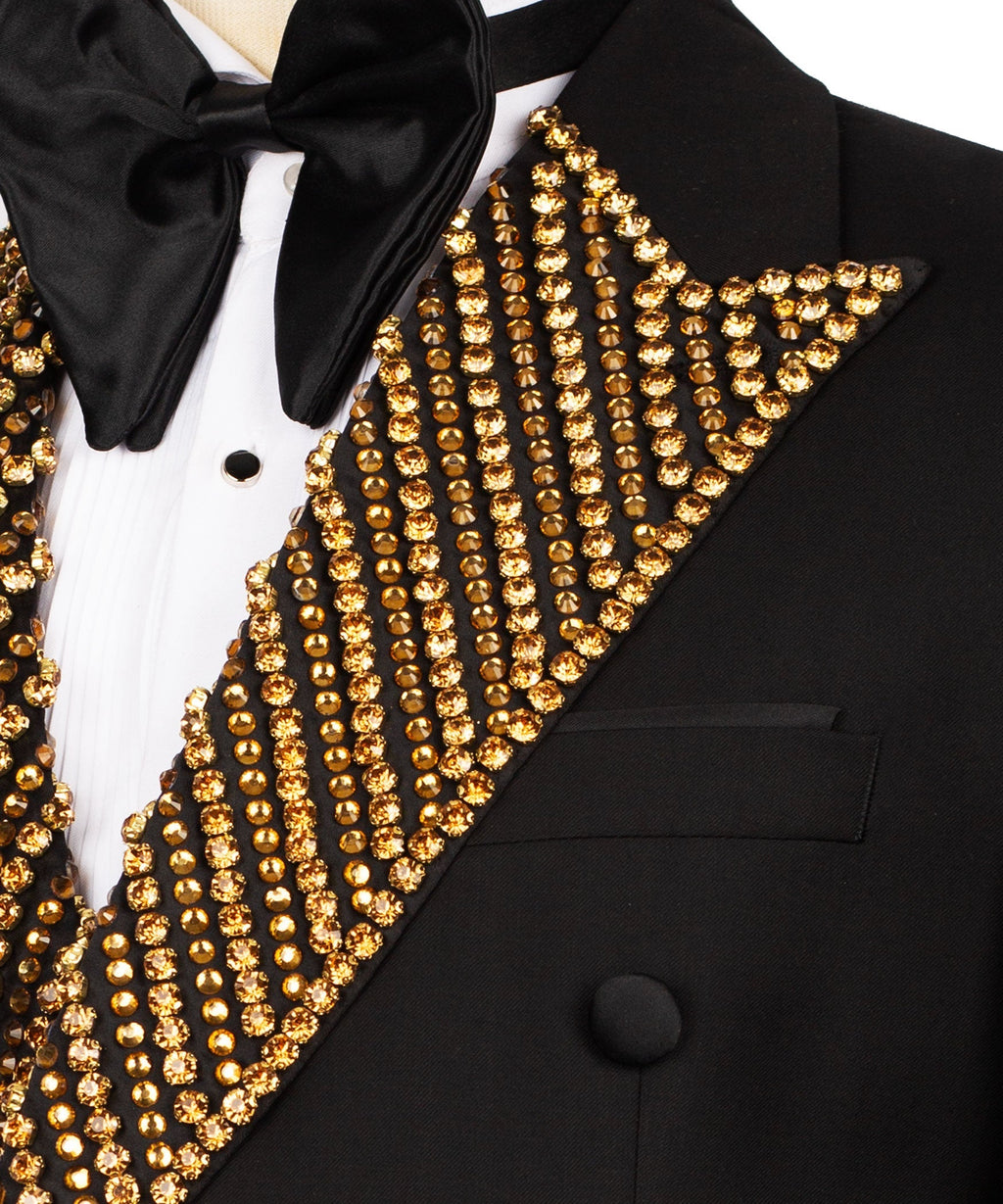 Close-up: gold beaded embroidered lapel on black tuxedo jacket with bow tie
