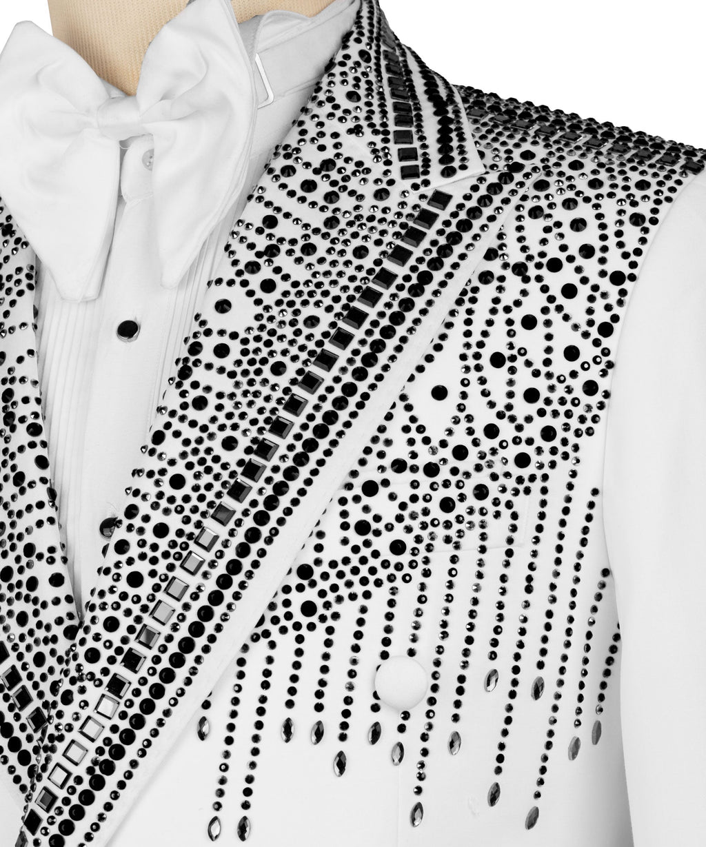 Close-up of white tuxedo lapel and pocket with black stone embroidery and buttons