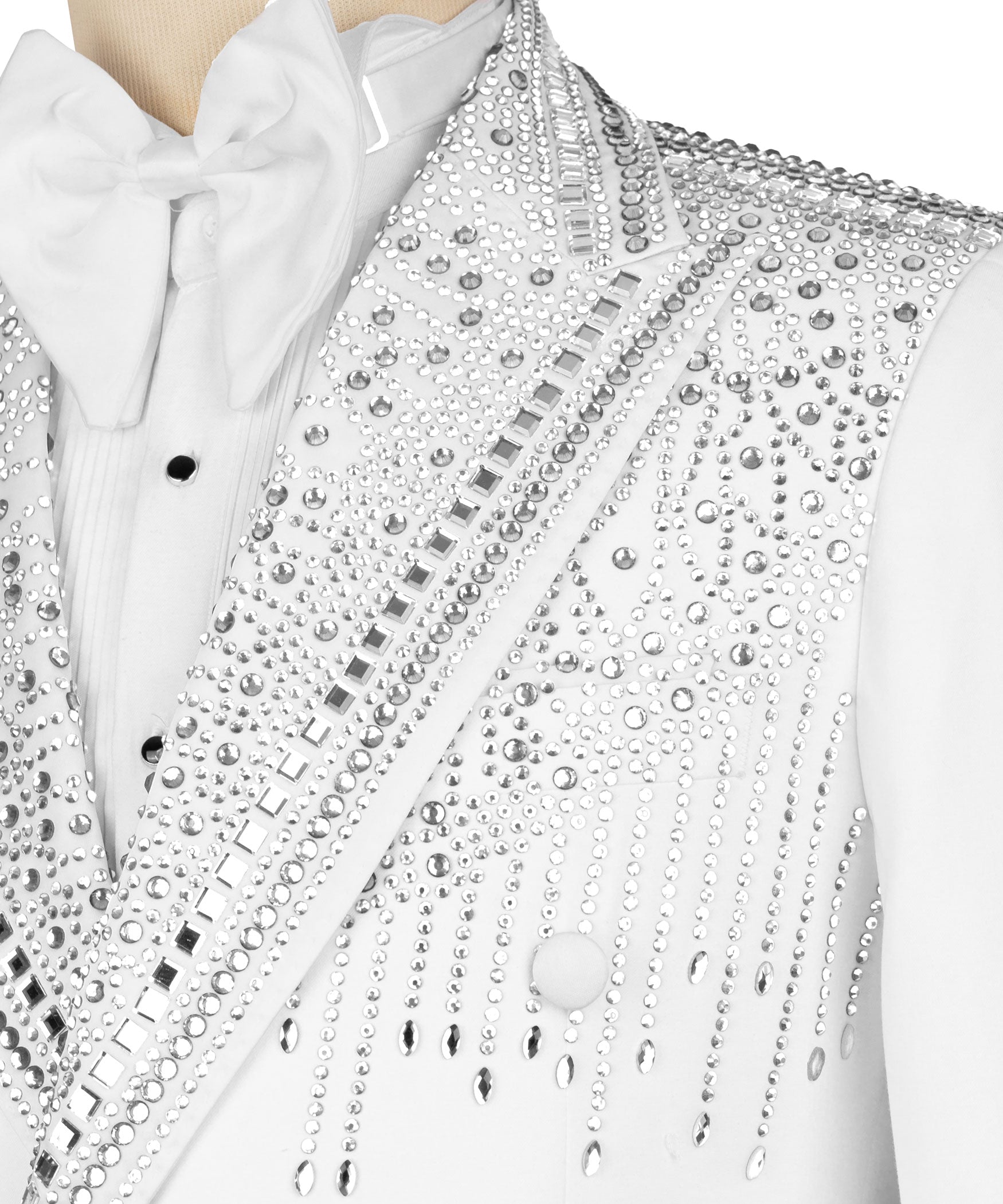 Close-up: white tuxedo lapel with rhinestone and metal-stud embroidery, bow tie