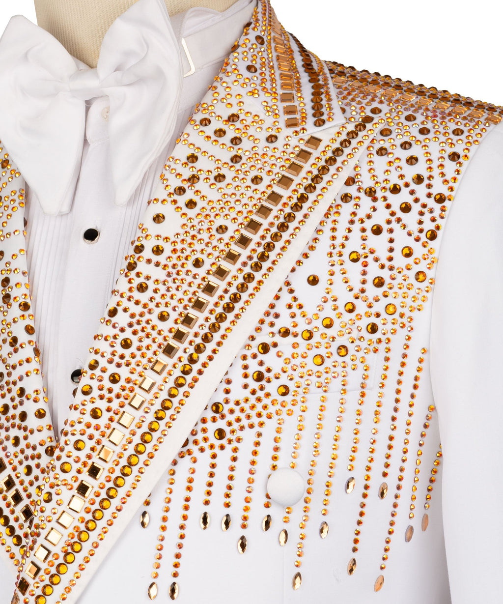 Close-up of white tuxedo lapel and front: gold stone-like embroidery and bow tie