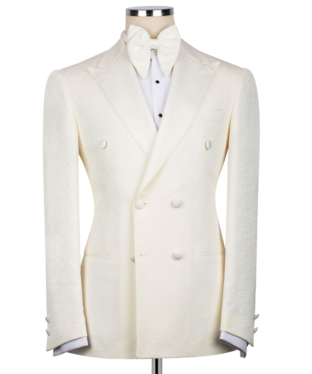 Cream tuxedo jacket with bow tie; double-breasted vest front with dark buttons