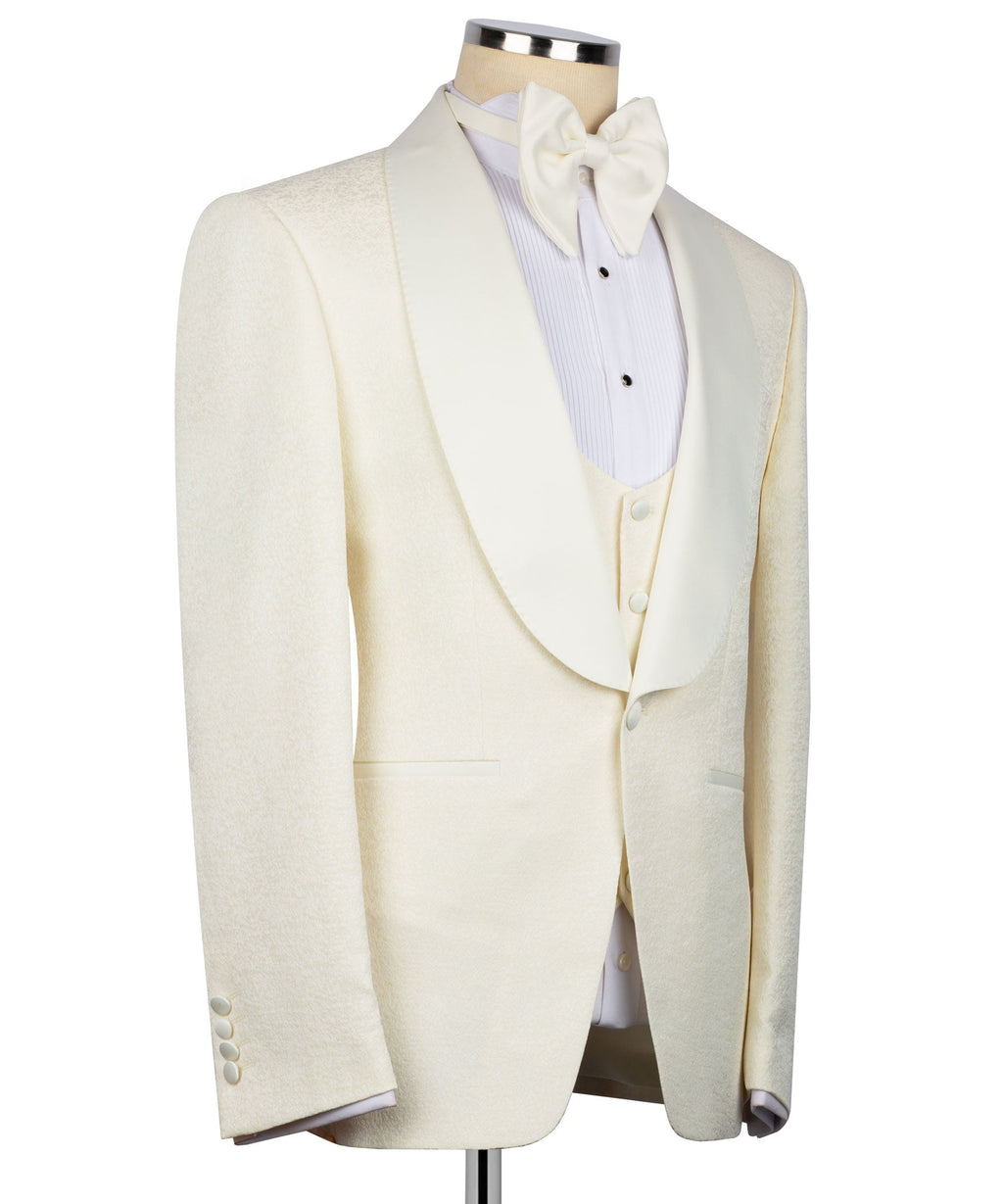 Cream tuxedo suit set on mannequin: single-breasted jacket with matching vest and bow tie