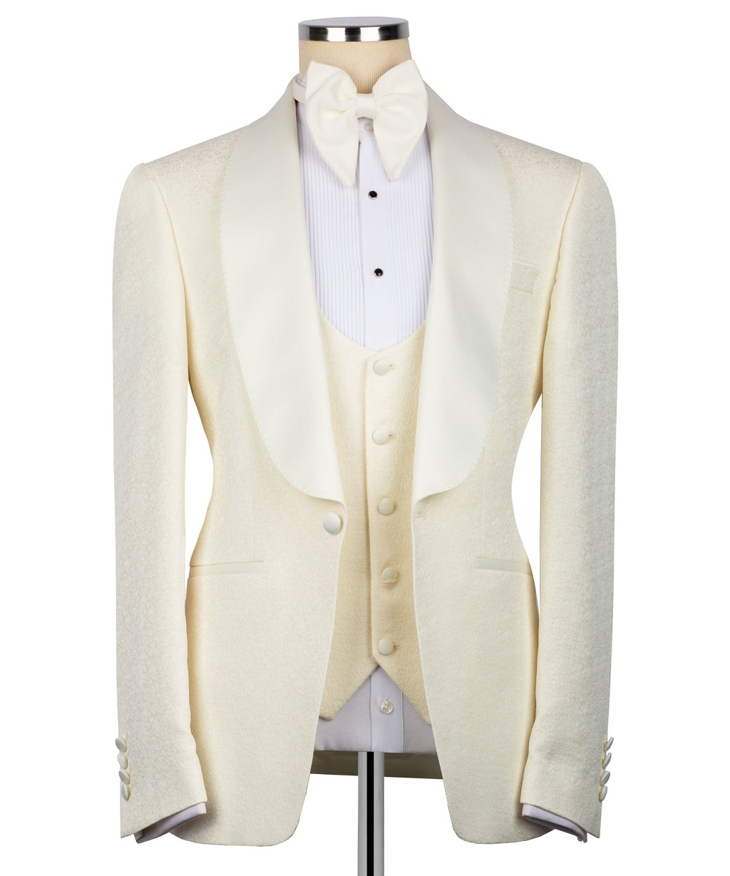 Cream three-piece tuxedo suit set with bow tie, vest, and tailored jacket front