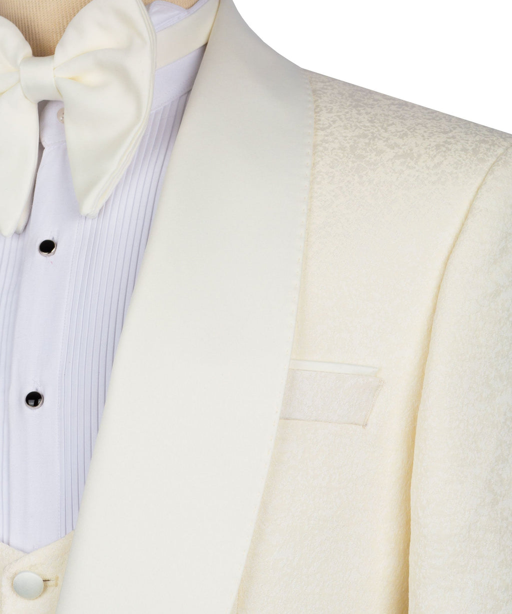Close-up of cream tuxedo jacket lapel and light vest with bow tie and button details