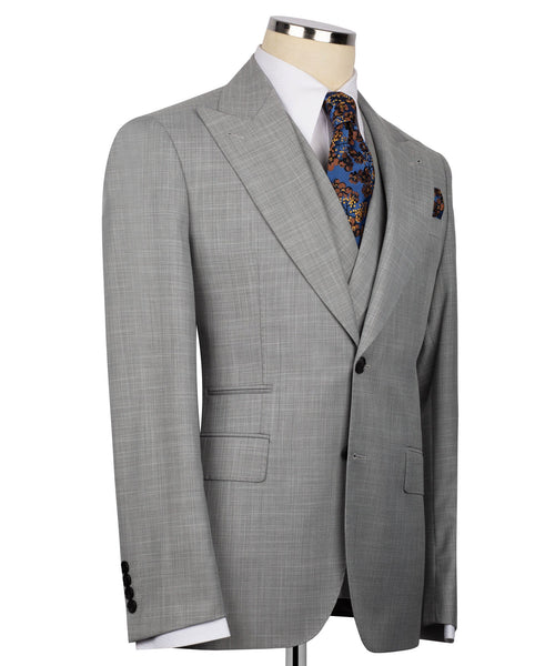 Grey suit jacket front view with patterned necktie and blue pocket square