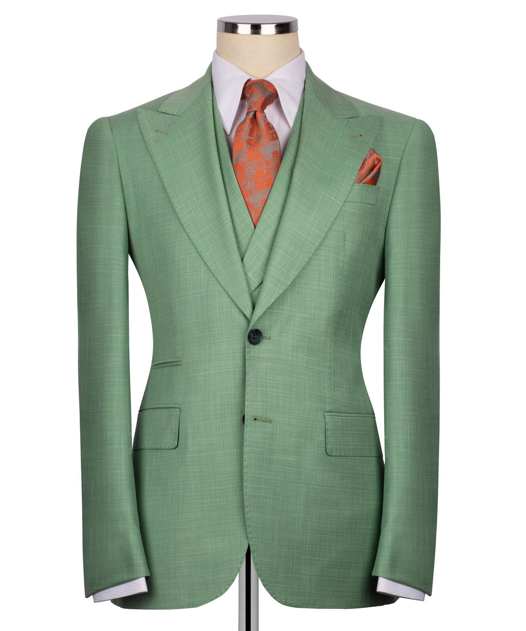 Back view of green suit jacket with single vent; orange patterned tie