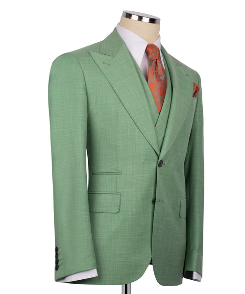 Green suit jacket with flap pockets and three-button front; orange patterned tie