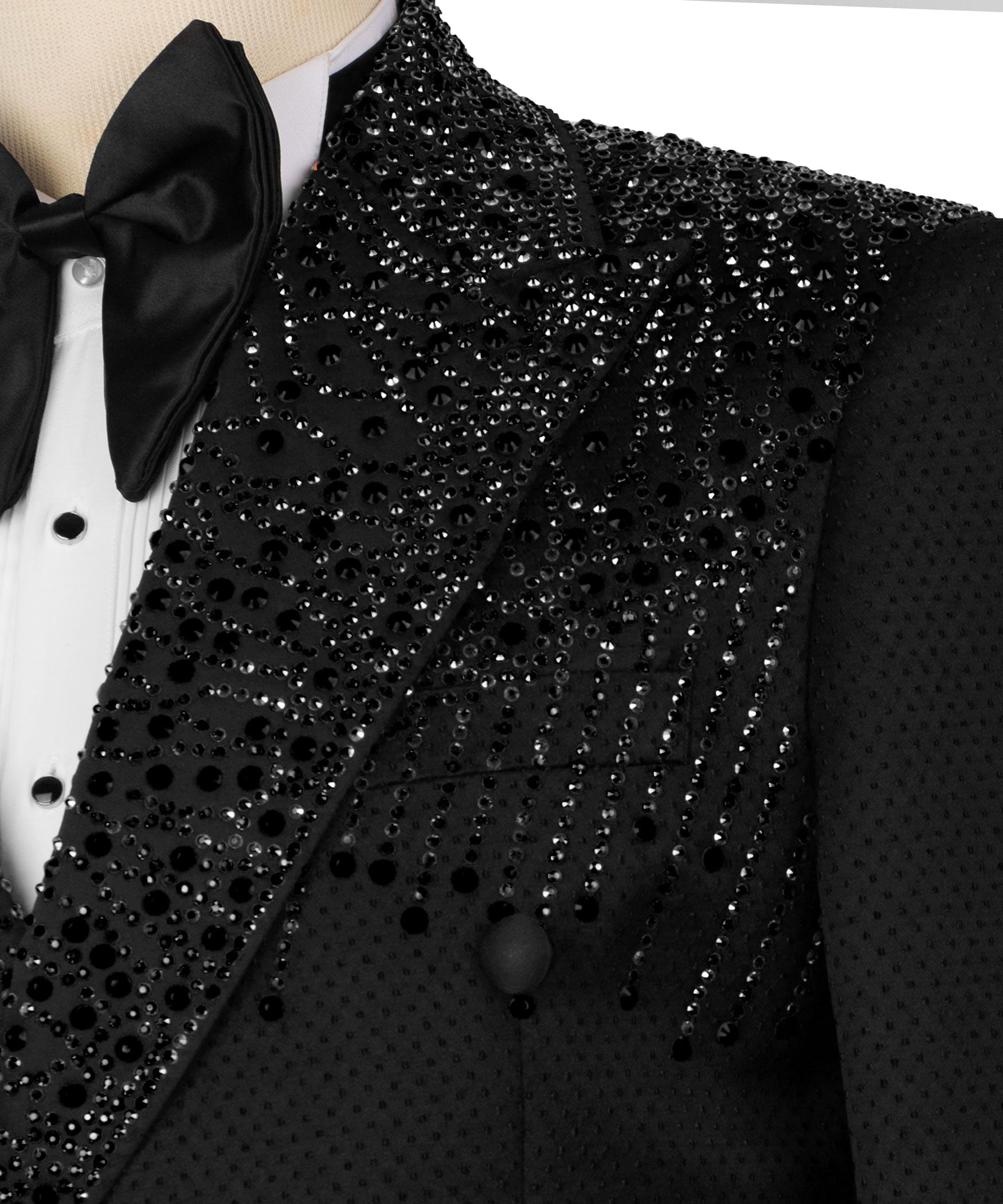 Close-up black tuxedo jacket with bow detail and sparkling stone embroidery