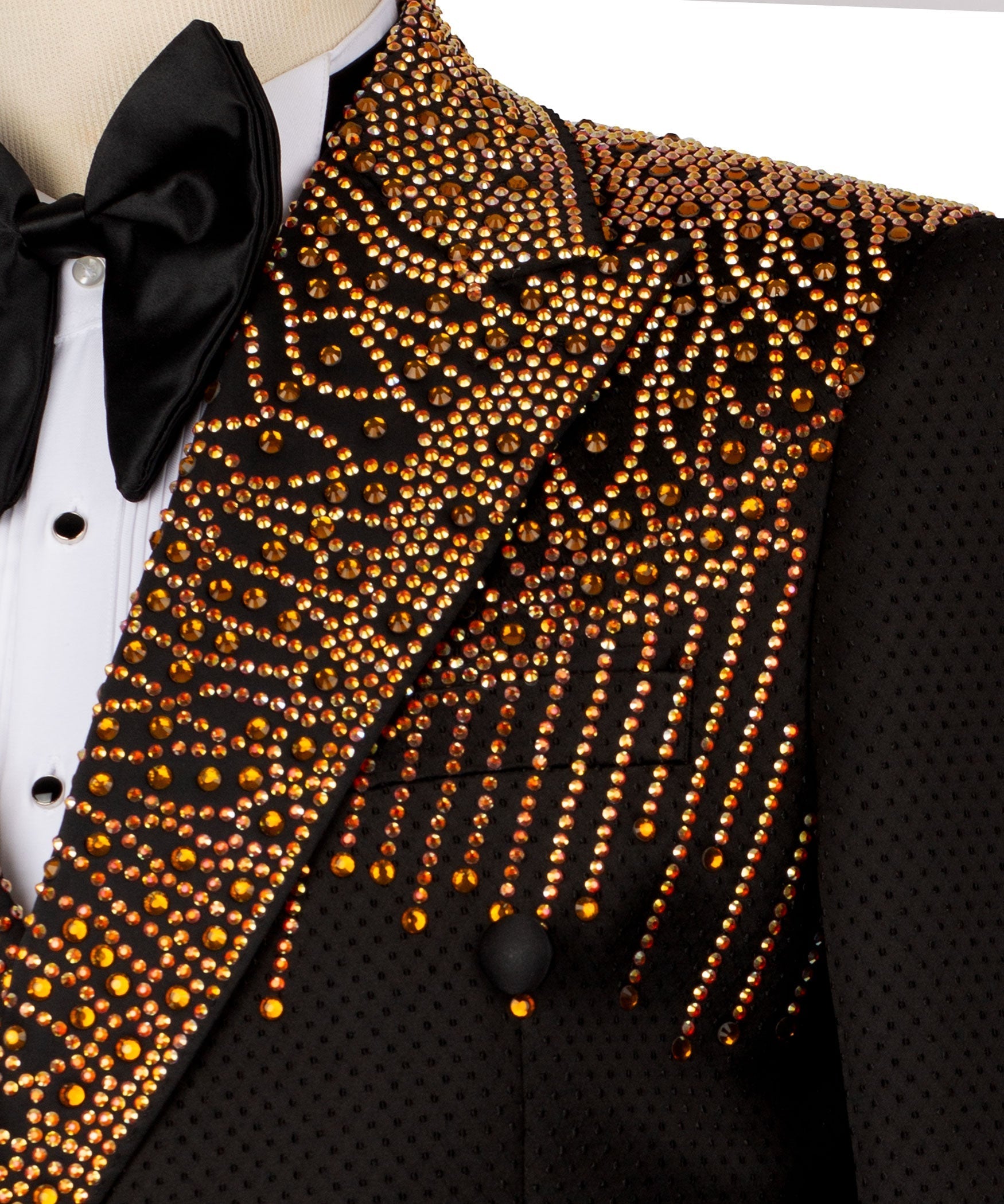 Gold stone-studded tuxedo lapel and buttons on black jacket with bow tie