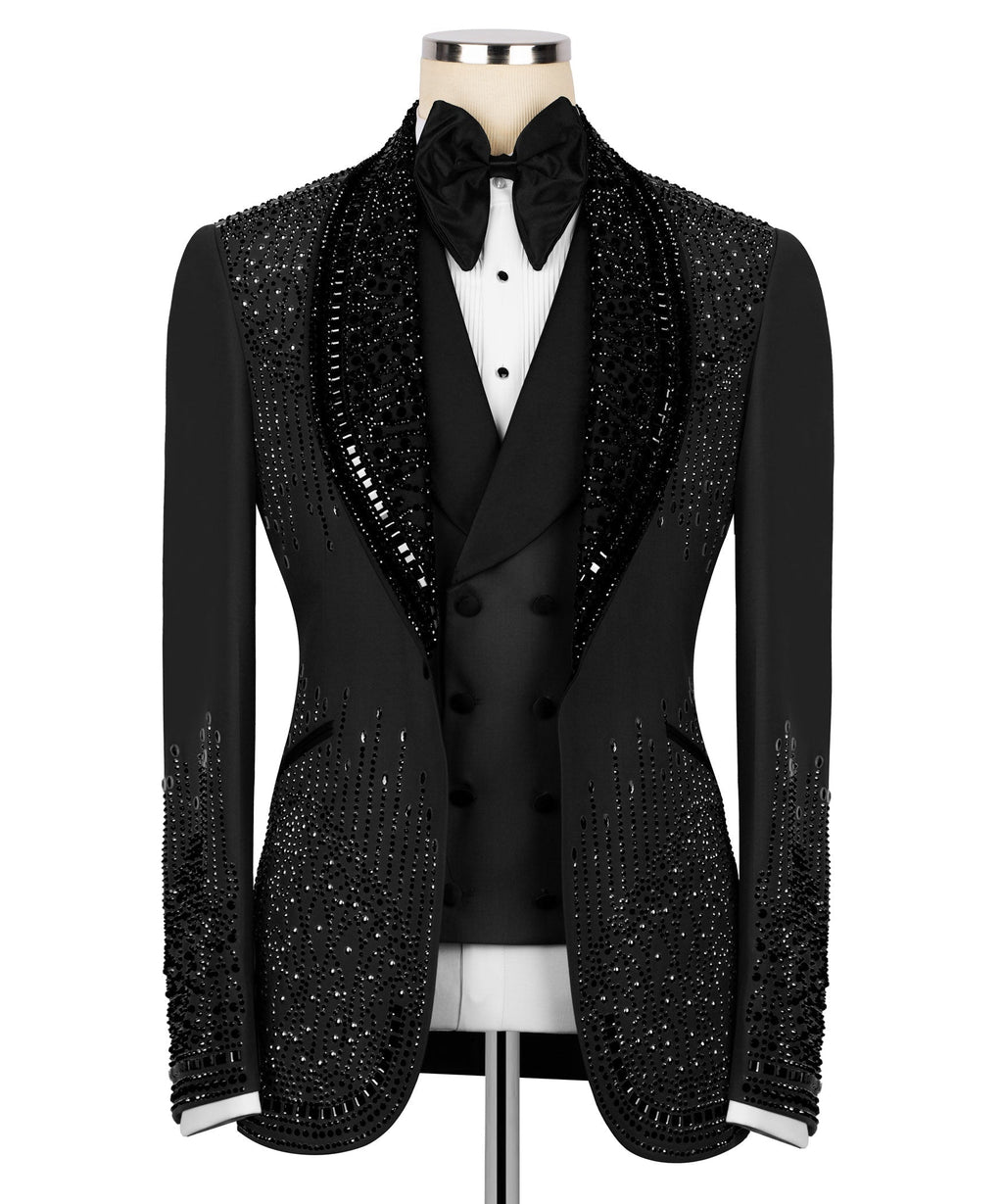 Black tuxedo jacket with stone-embellished lapels and black bow tie over white vest