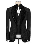 Black tuxedo jacket with stone-embellished lapels and black bow tie over white vest