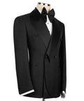 Black tuxedo blazer with geometric shawl collar, bow tie, and vest; side view