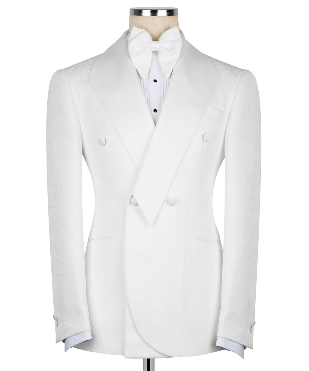 White tuxedo jacket with geometric bow tie, pointed lapels, and matching vest
