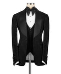 Black three-piece tuxedo suit with bow tie, satin lapels, and striped waistcoat