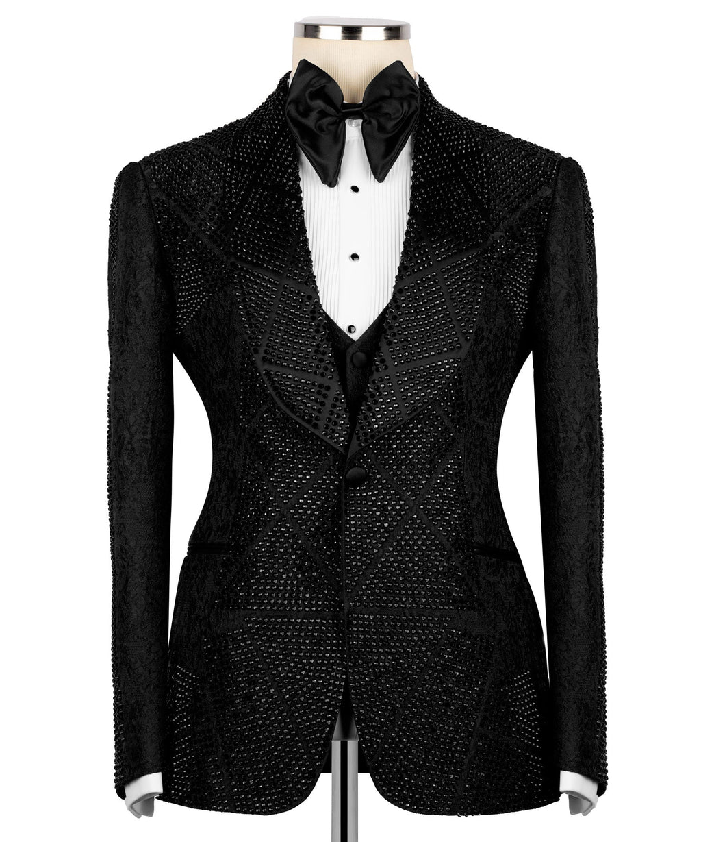 Front view of black stone-embroidered tuxedo jacket with satin bow tie and dark waistcoat