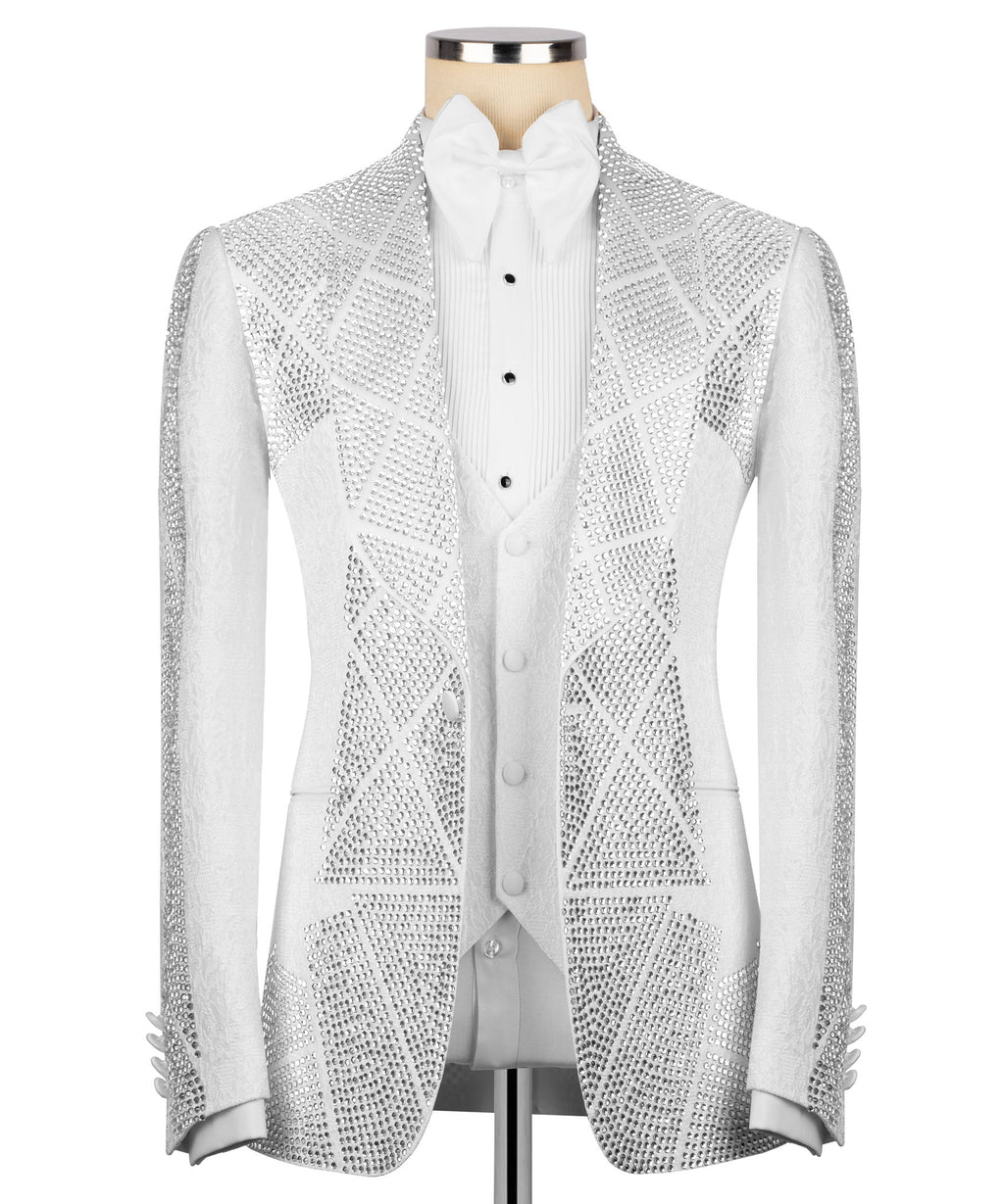 White tuxedo jacket with silver stone embroidery and peak lapels; white shirt front