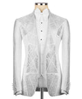 White tuxedo jacket with silver stone embroidery and peak lapels; white shirt front