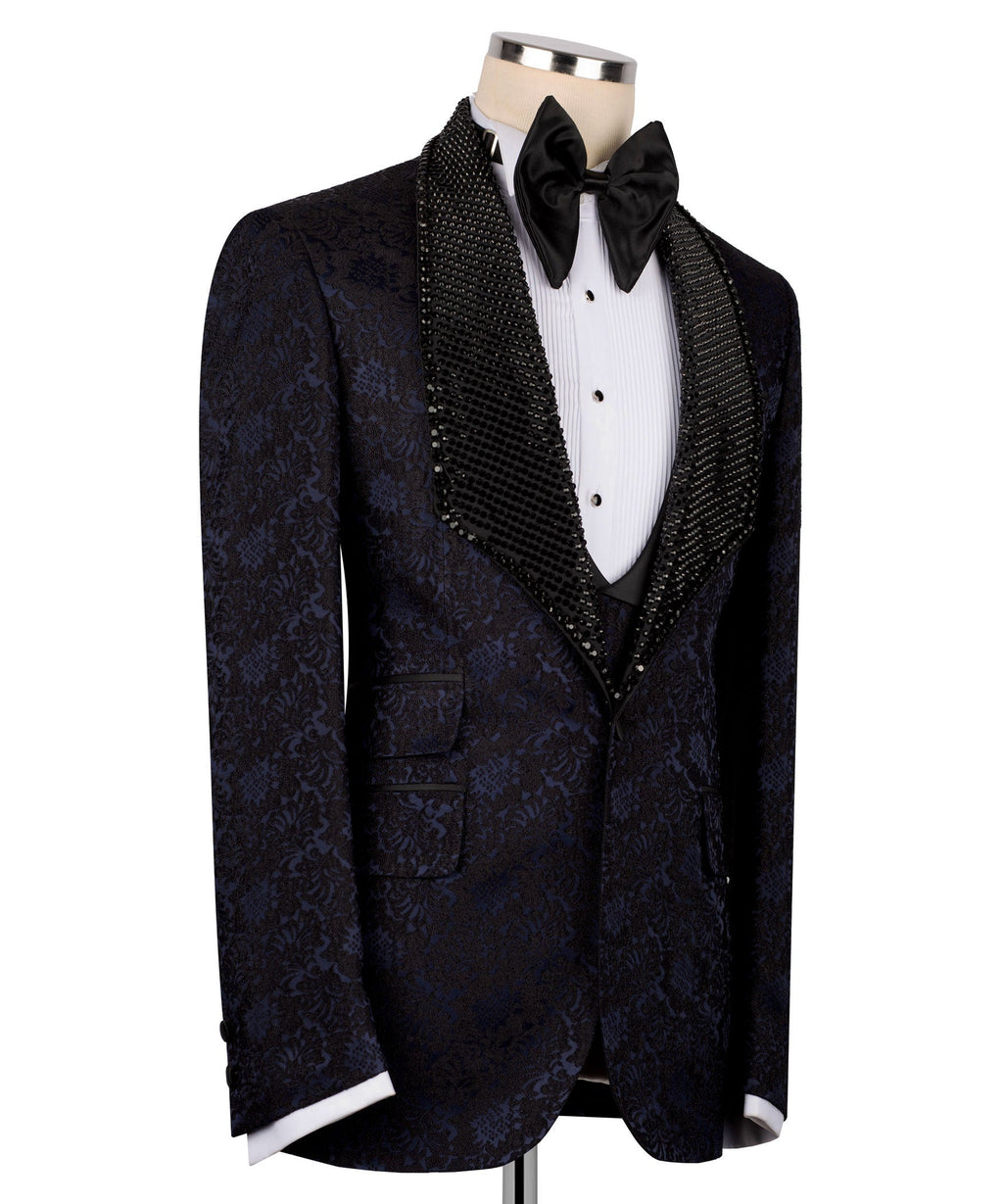 Navy patterned tuxedo jacket with black sequin velvet trim and bow tie, white shirt and vest