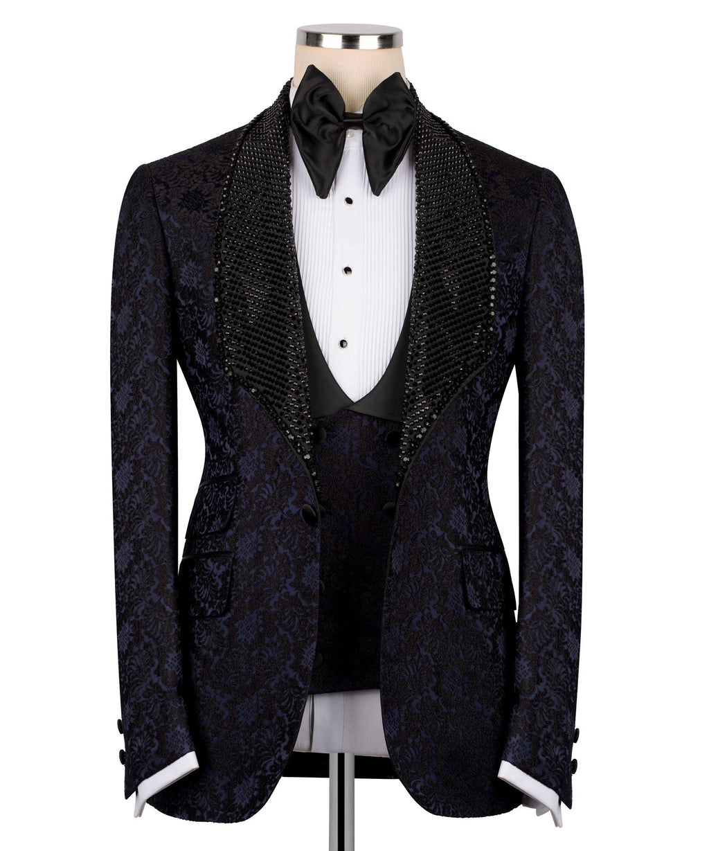 Navy patterned tuxedo jacket with black sequin velvet collar, bow tie, and waistcoat