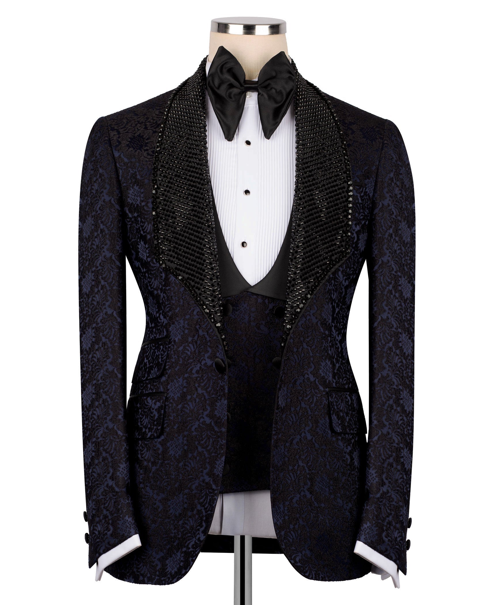 Navy patterned tuxedo jacket with black sequin velvet collar, bow tie, and waistcoat