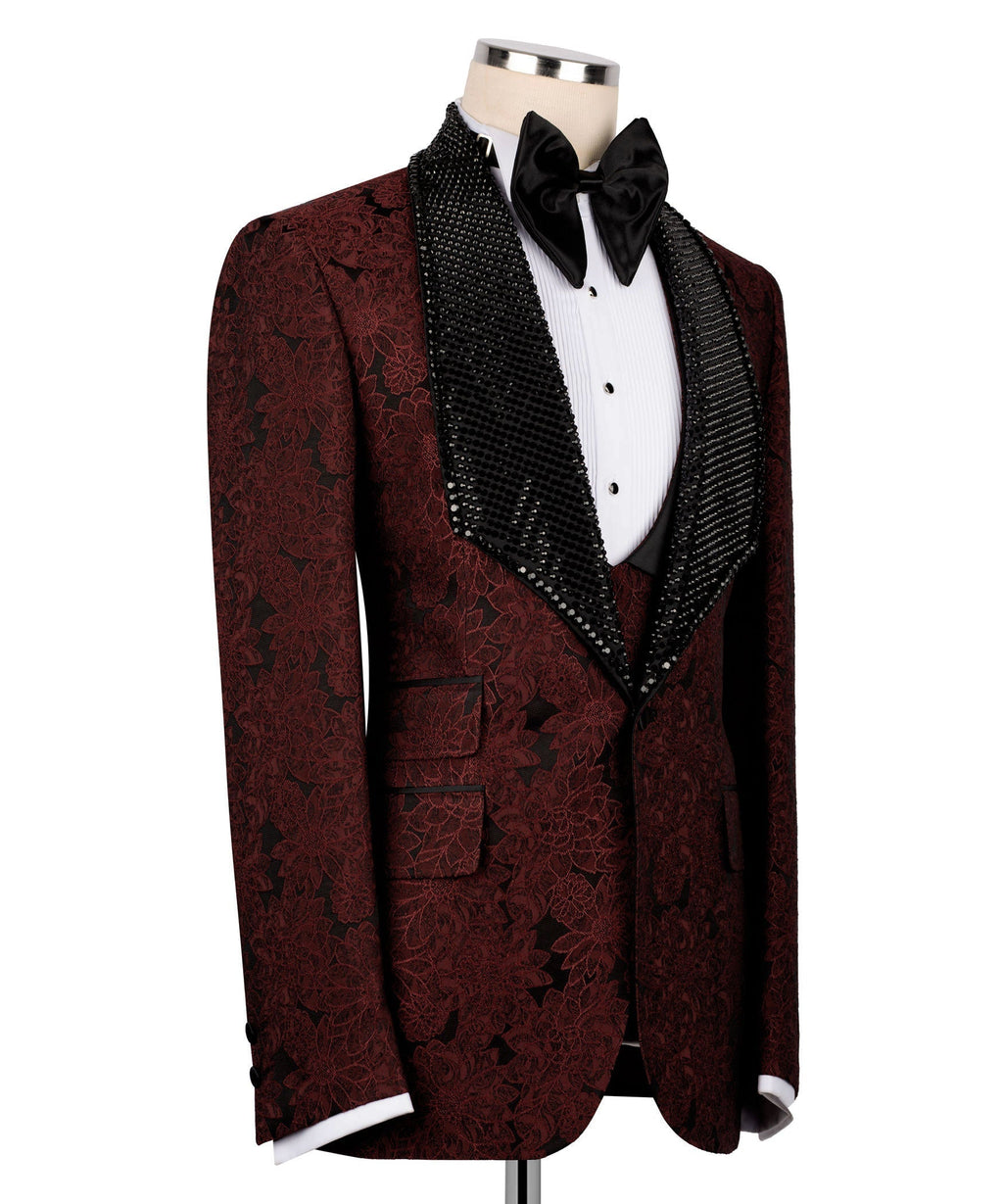 Red embroidered tuxedo jacket with black velvet collar, bow tie, and sequin vest