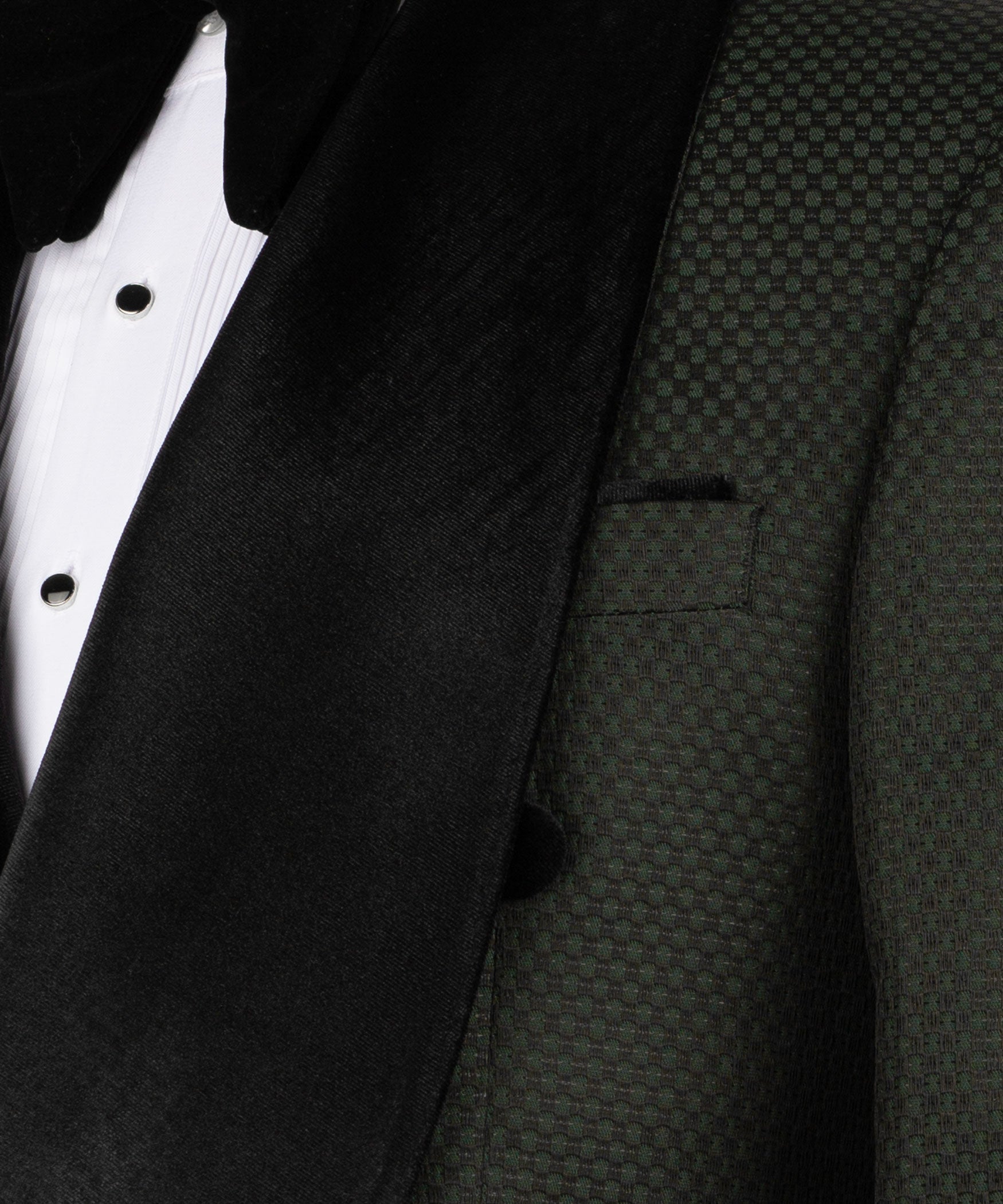Close-up of black velvet tuxedo lapel over textured vest fabric