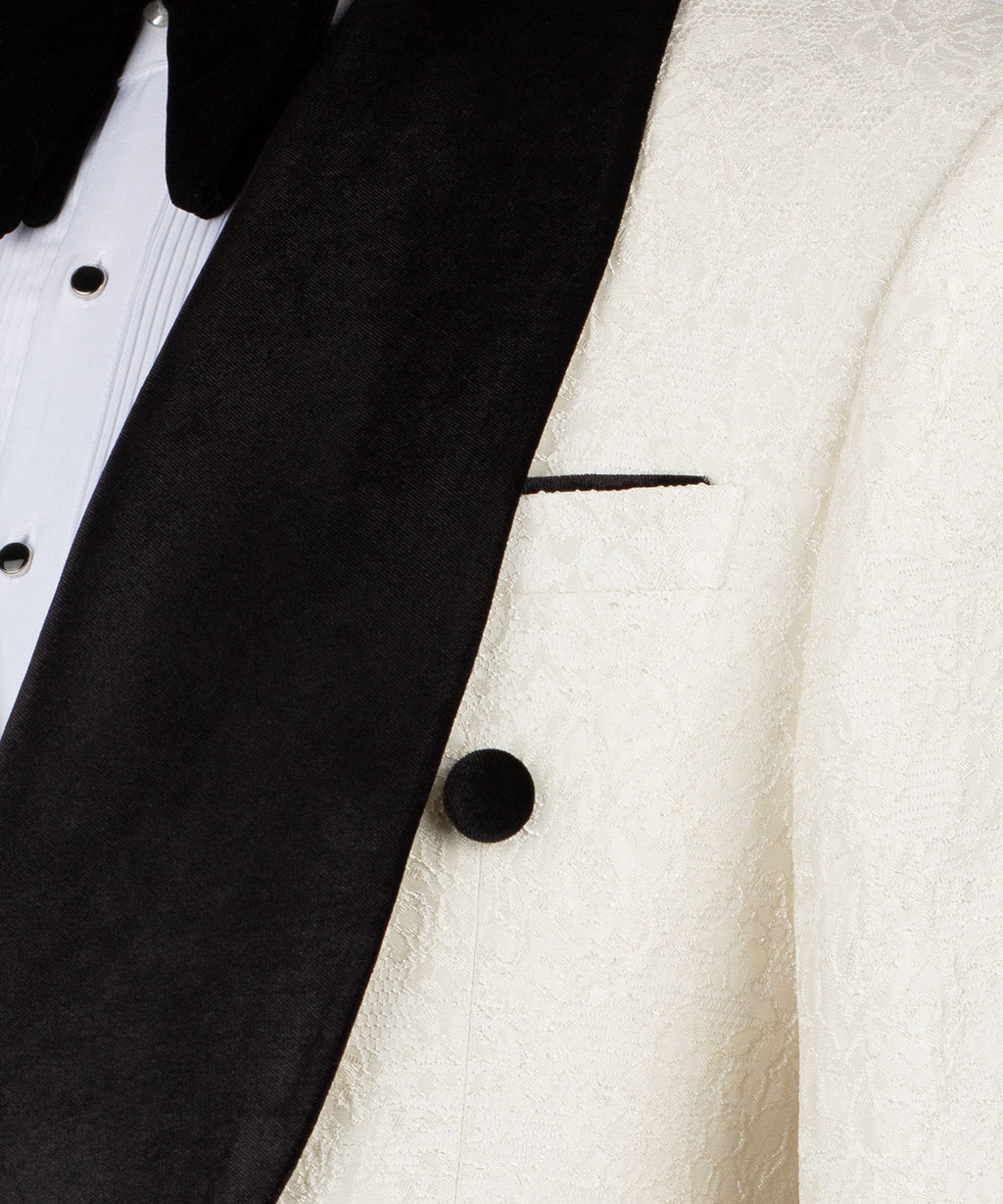 Close-up of black velvet lapel with cream jacket button detail
