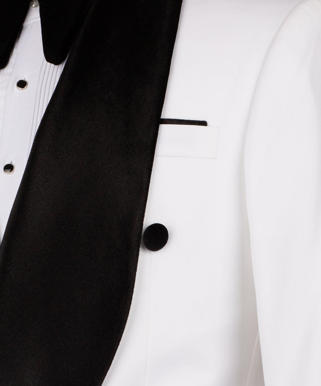 Close-up of black velvet lapel and white vest with buttons