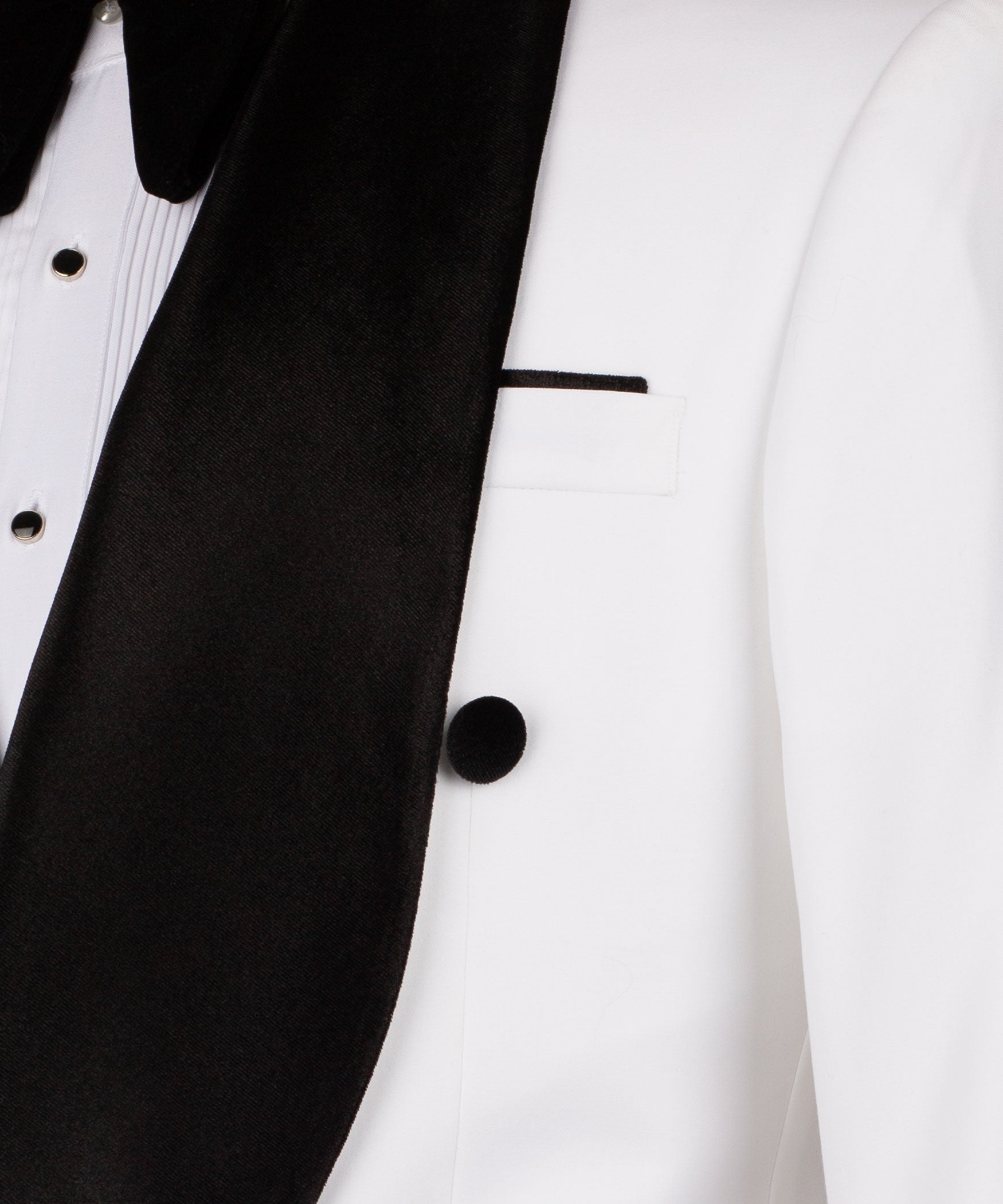 Close-up of black velvet lapel and white vest with buttons