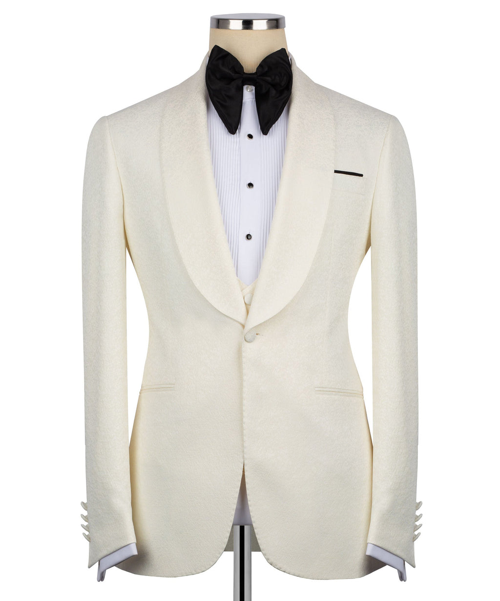 Cream tuxedo jacket front with black bow tie, white striped shirt, and side vents