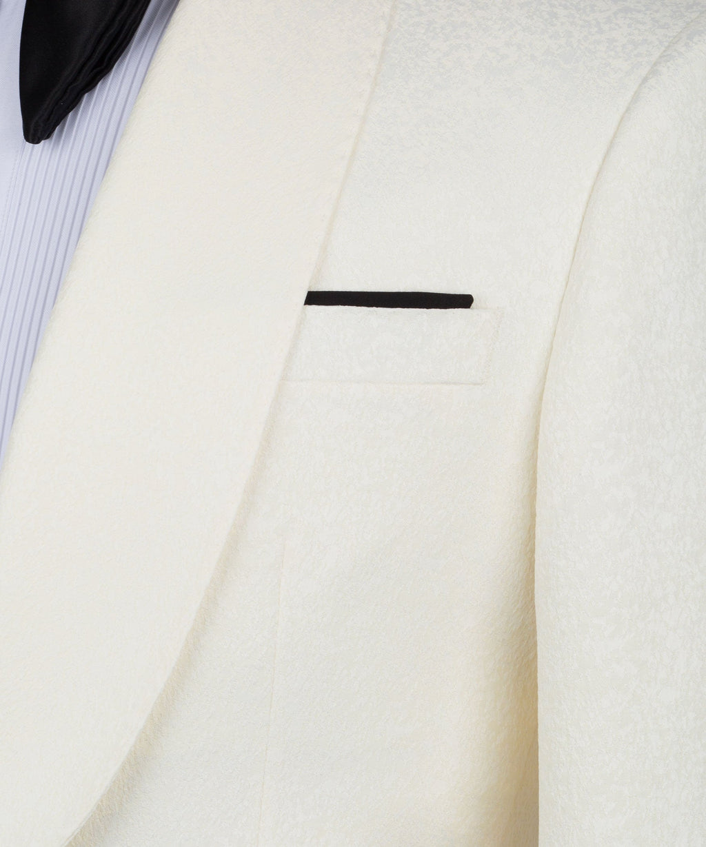 Cream tuxedo jacket lapel and pocket detail with black trim bar