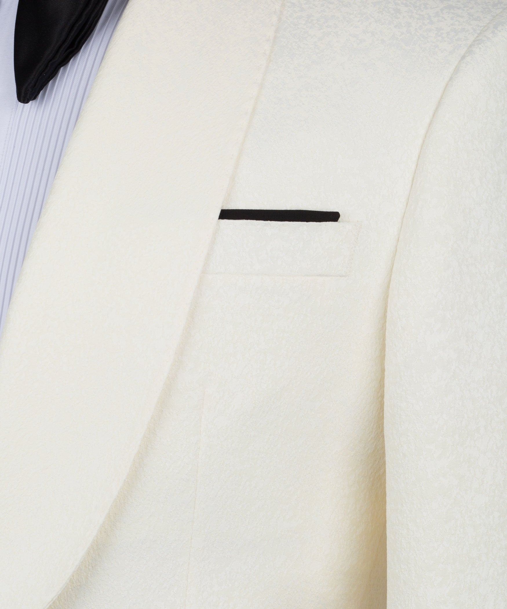 Cream tuxedo jacket lapel and pocket detail with black trim bar