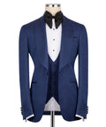 Navy tuxedo jacket with satin peak lapels, black bow tie, and white striped shirt insert