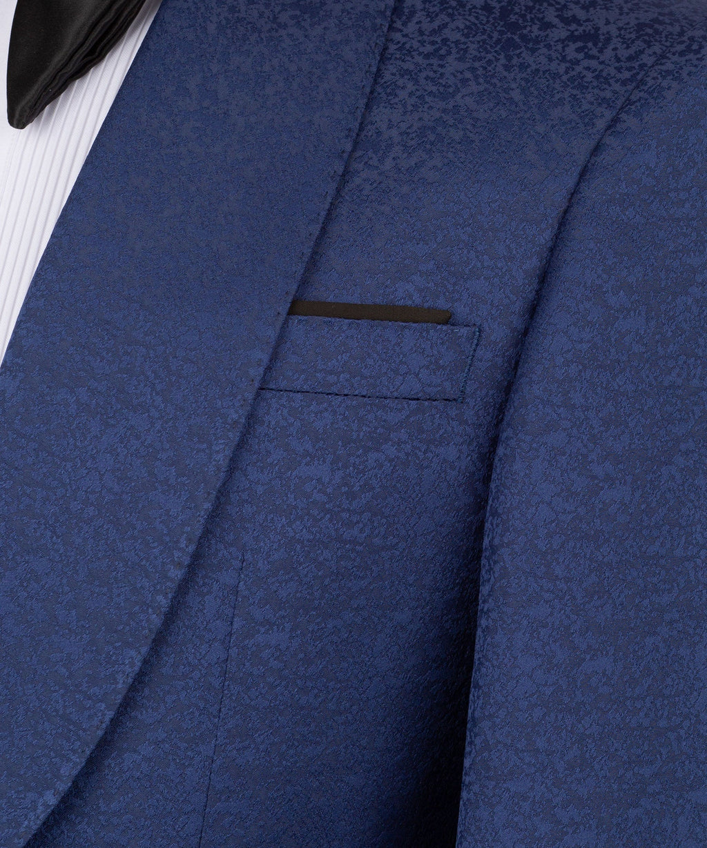 Navy tuxedo jacket pocket and lapel detail with subtle textured fabric