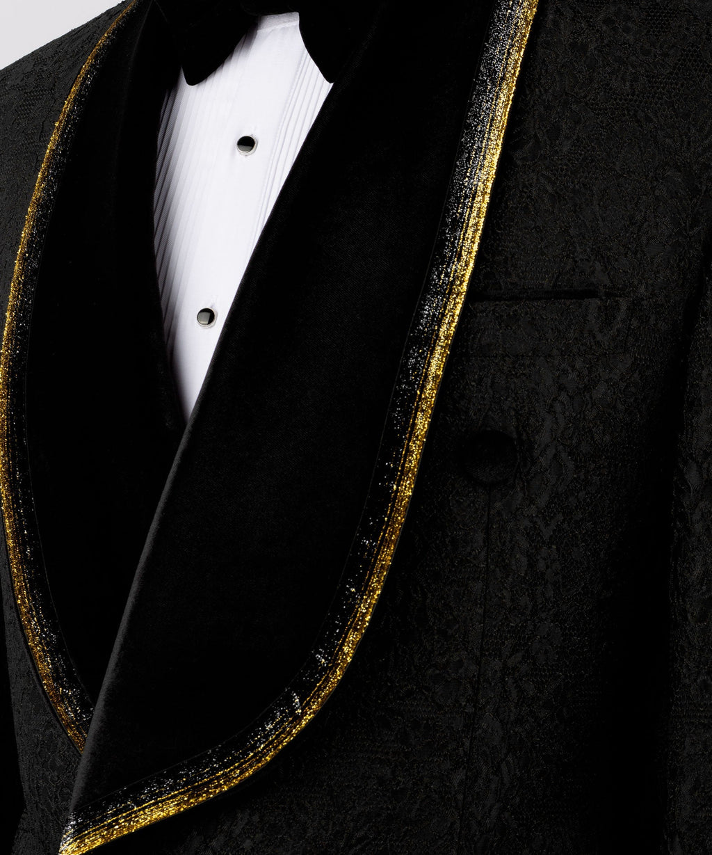 Close-up of black velvet lapels with gold embroidered trim and black satin vest