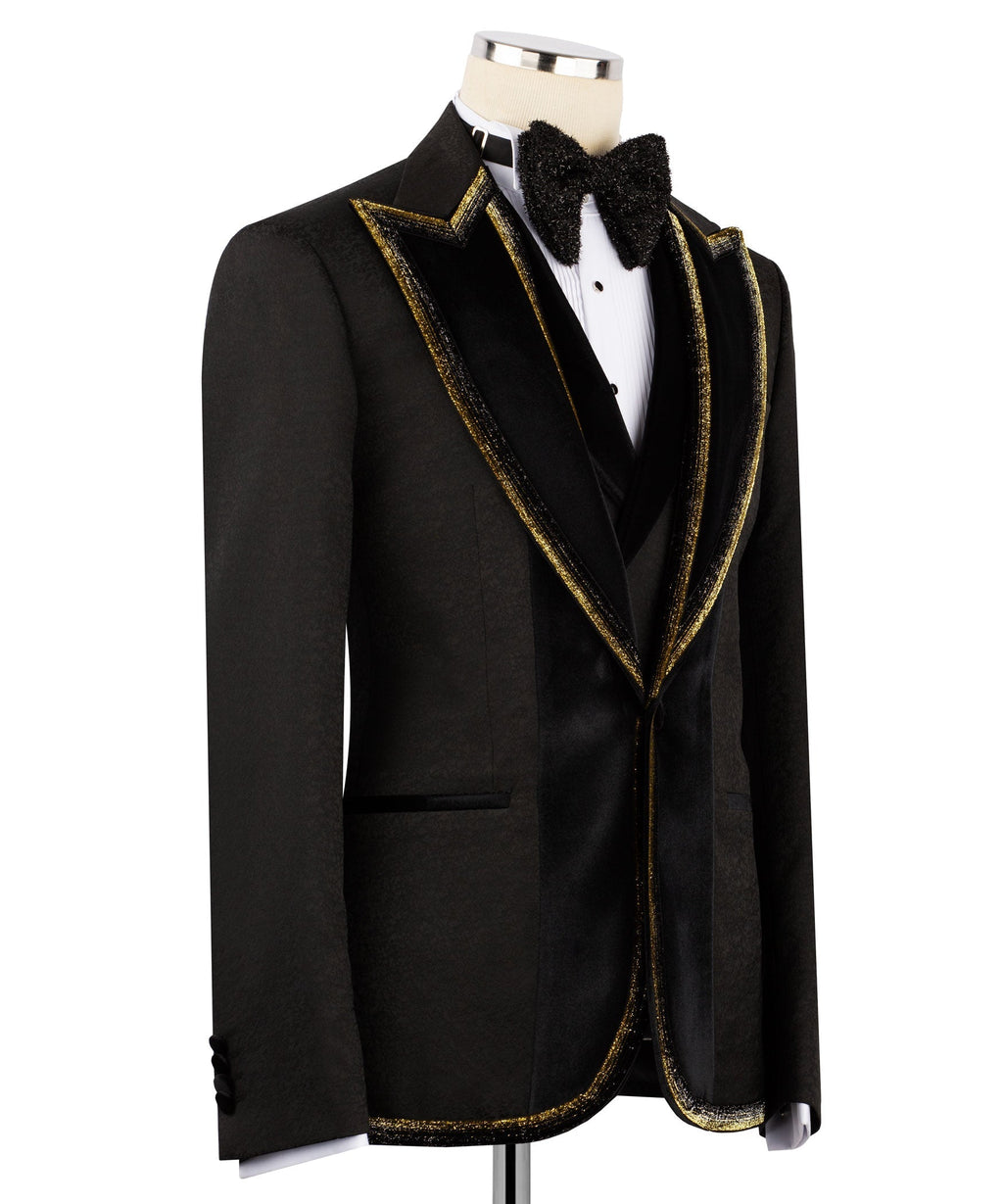Black tuxedo jacket side view with gold-trimmed lapels and embroidered collar