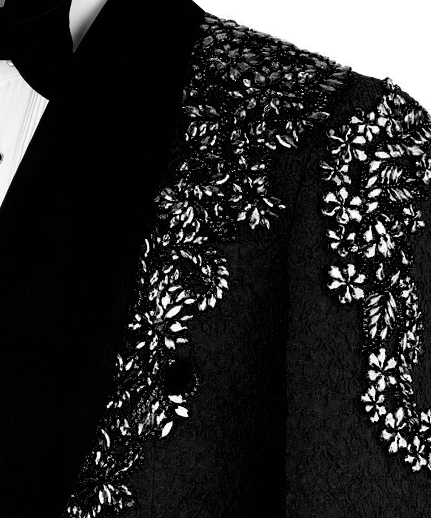 Silver stone floral embroidery on black textured jacket shoulder and upper arm