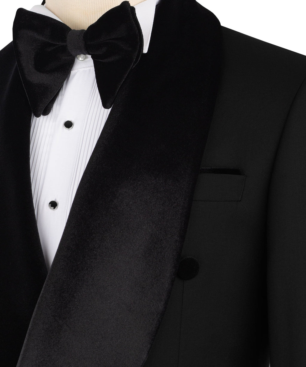 Close-up: black velvet bow tie and velvet-trimmed tuxedo lapel with pocket