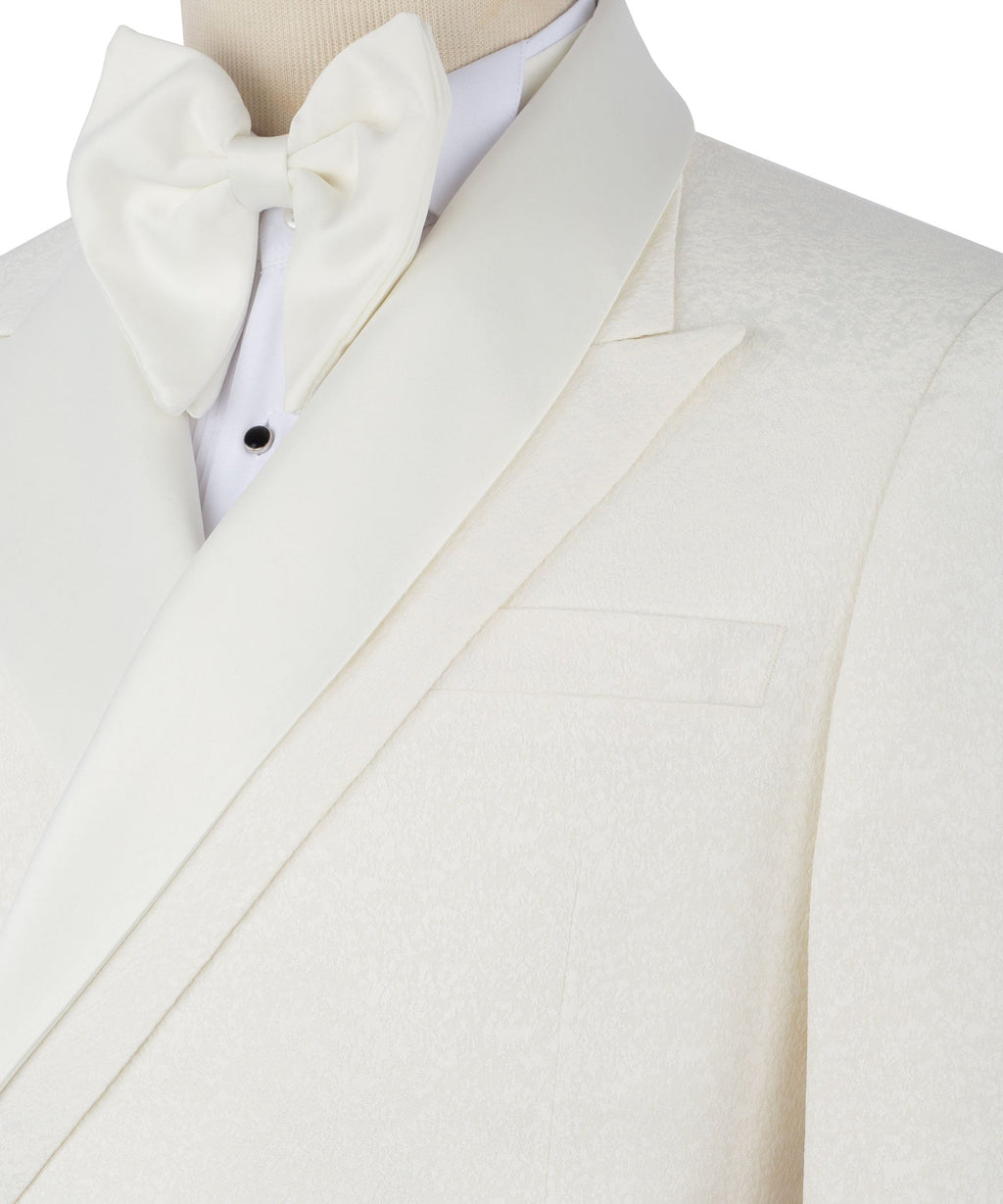 Close-up of cream tuxedo blazer lapel, bow tie, and single chest pocket