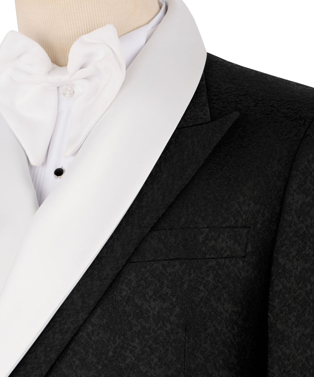 Close-up: black tuxedo jacket satin-trim lapel, white bow tie and dress shirt