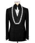 Black tuxedo suit with white stone-embroidered lapels, bow tie, and vest