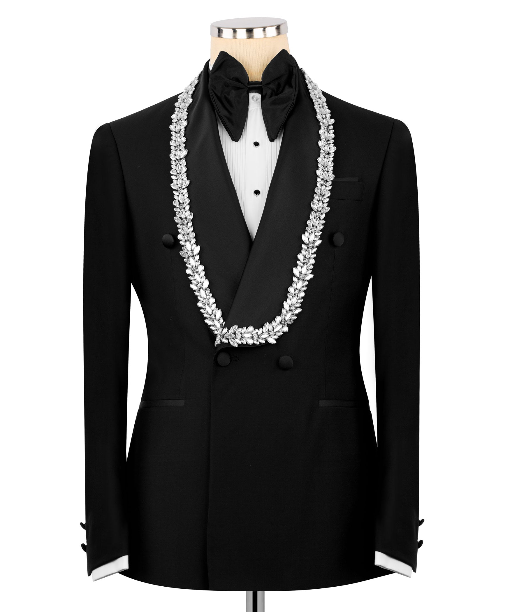 Black tuxedo suit with white stone-embroidered lapels, bow tie, and vest