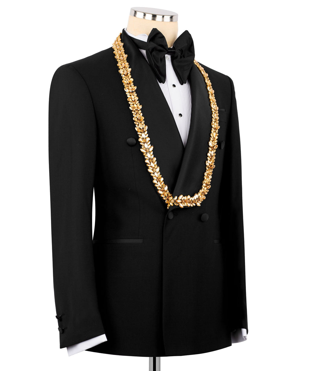 Black tuxedo jacket and vest with gold ornate chain, black bow tie and lapels