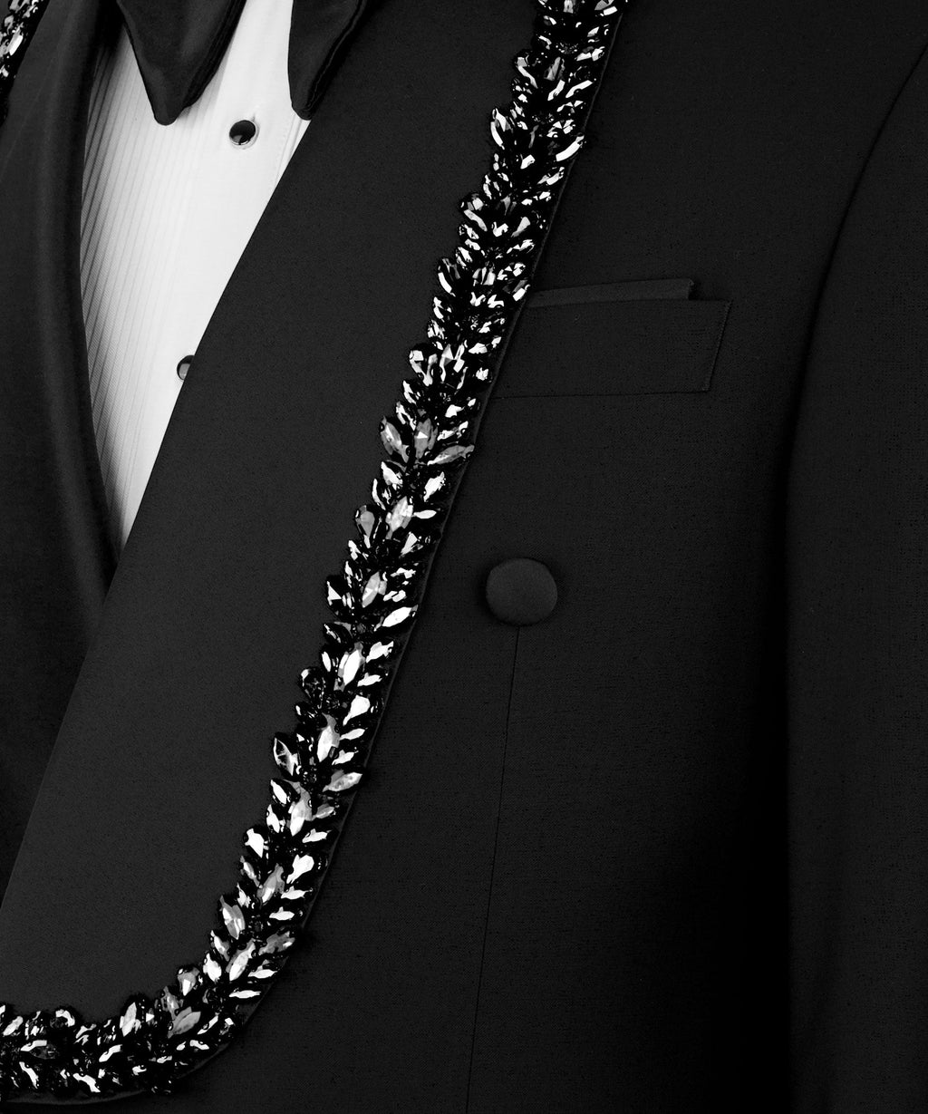 Close-up: stone-embroidered trim along tuxedo lapel with breast pocket detail